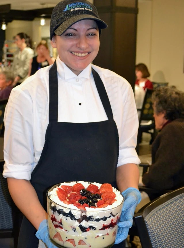 Server holding trifle dessert