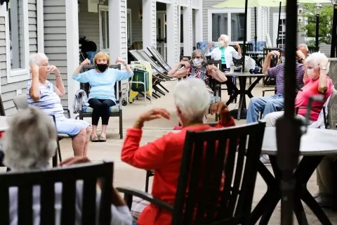 Seniors in exercise class outdoors
