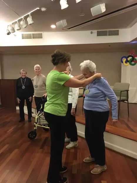 Senior living staff helping resident