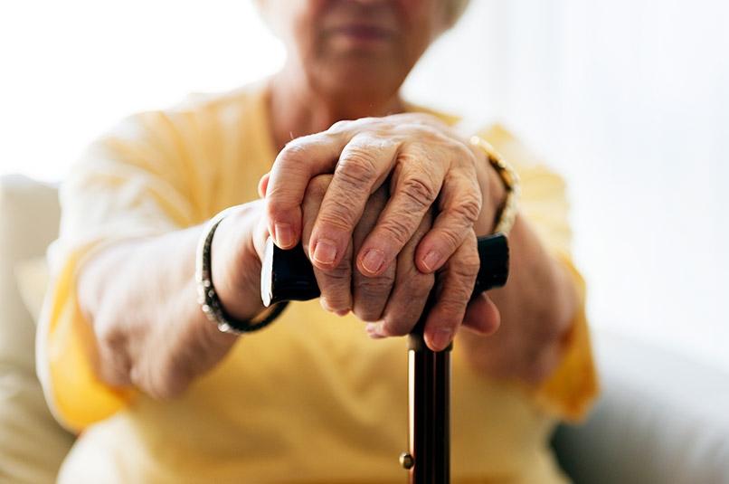 Senior woman holding cane