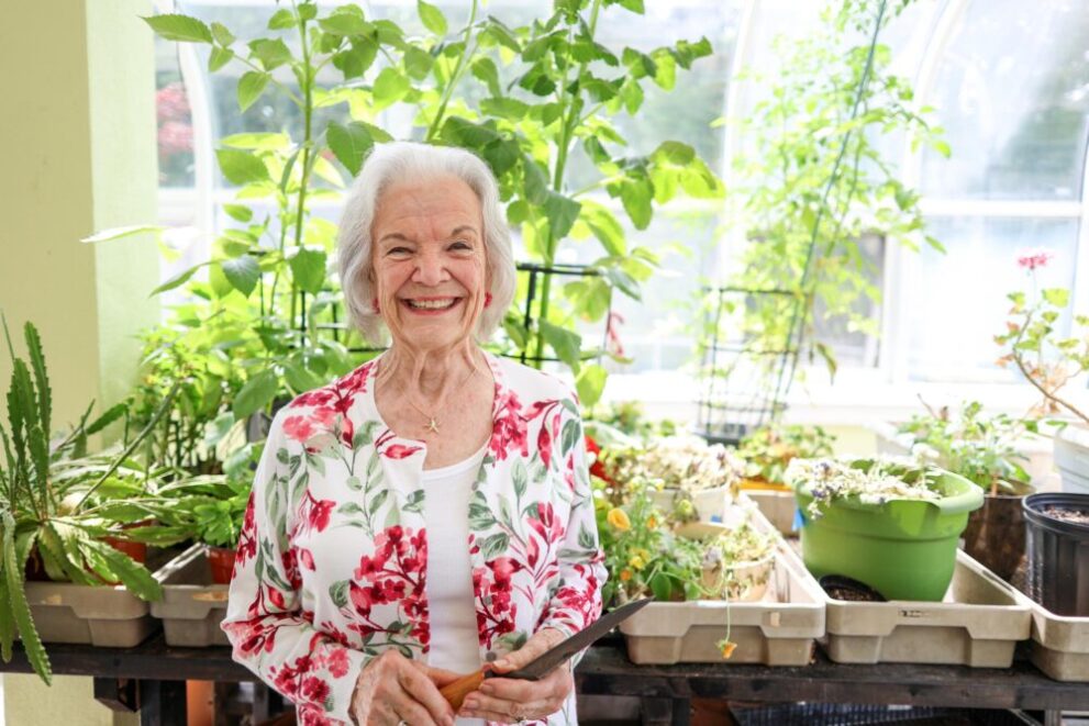 Resident Celeste Hurley in the greenhouse