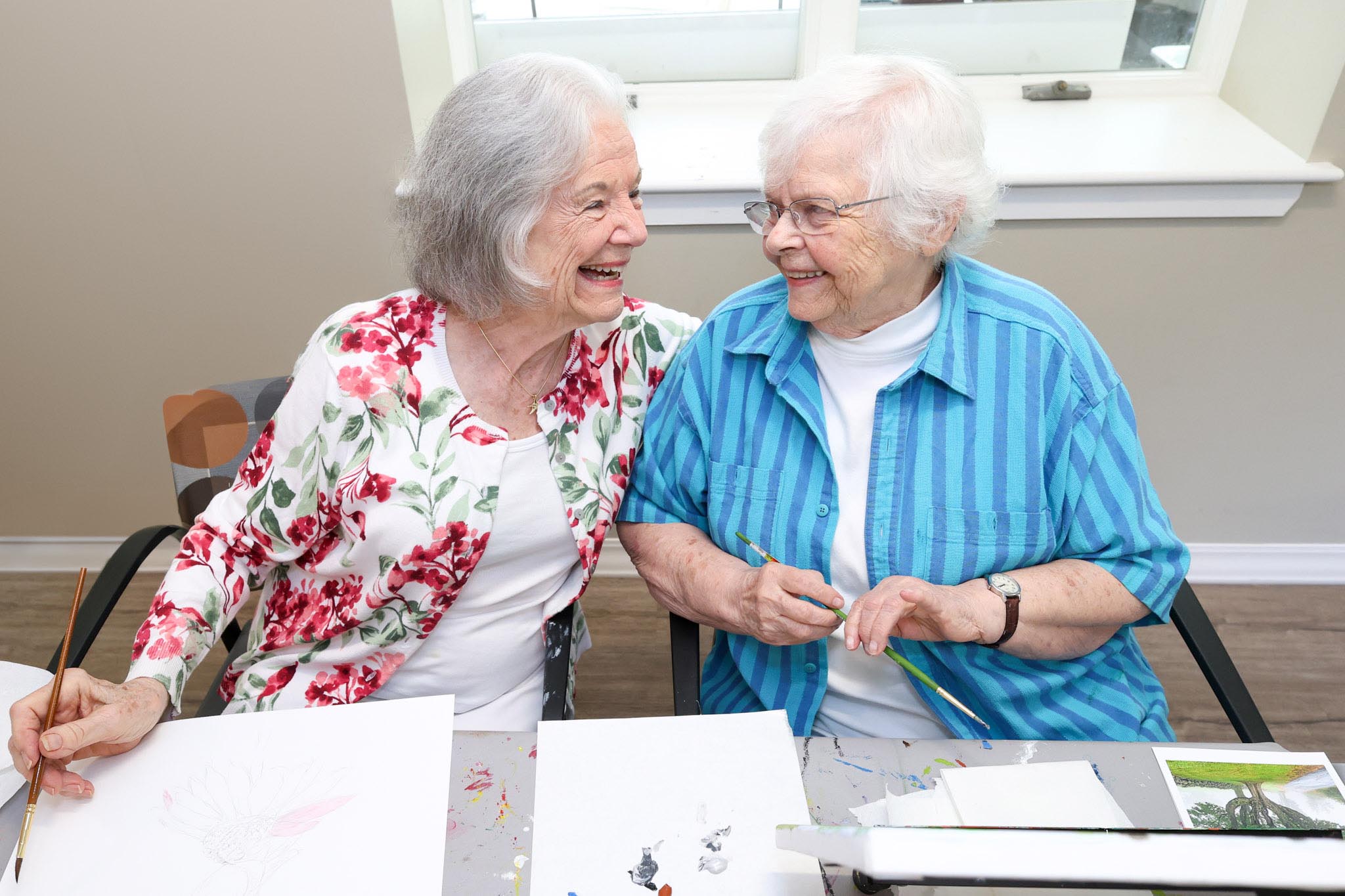 Residents painting in the activities room