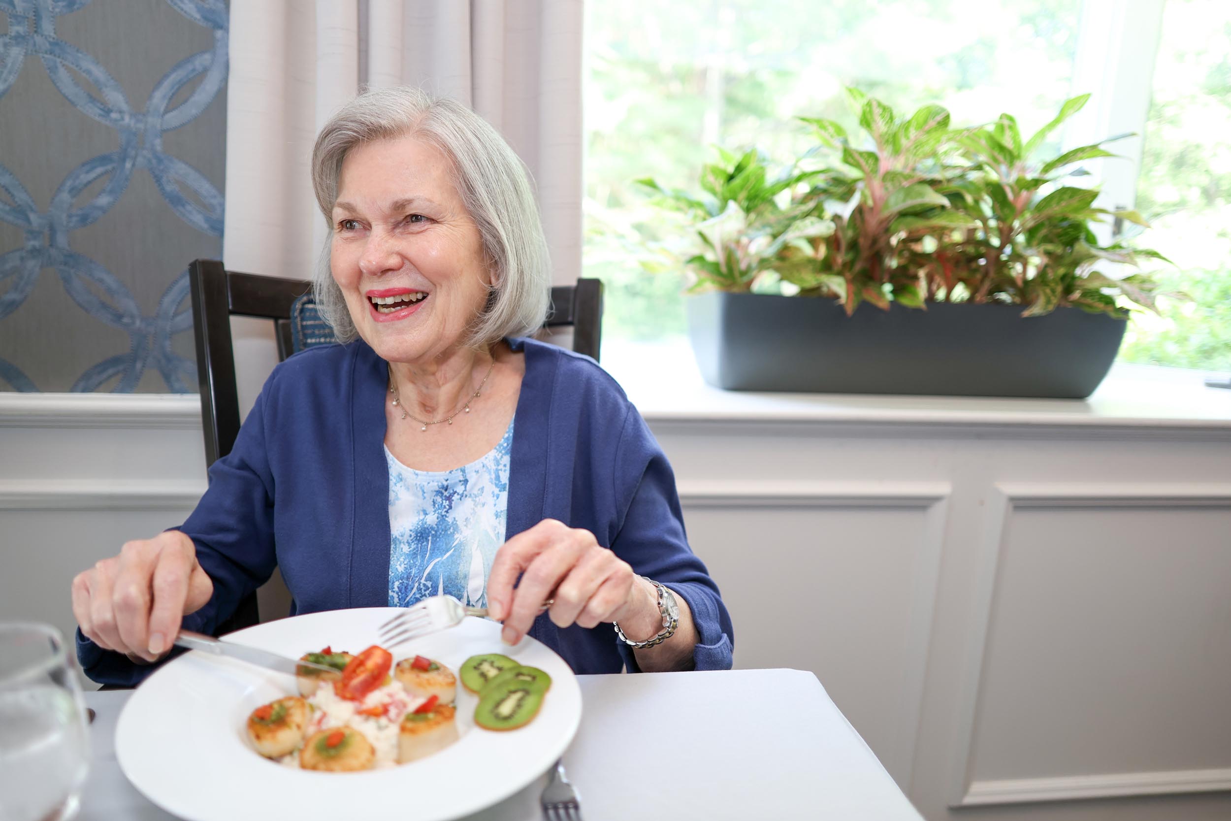 Resident Lloyd eating in the dining room