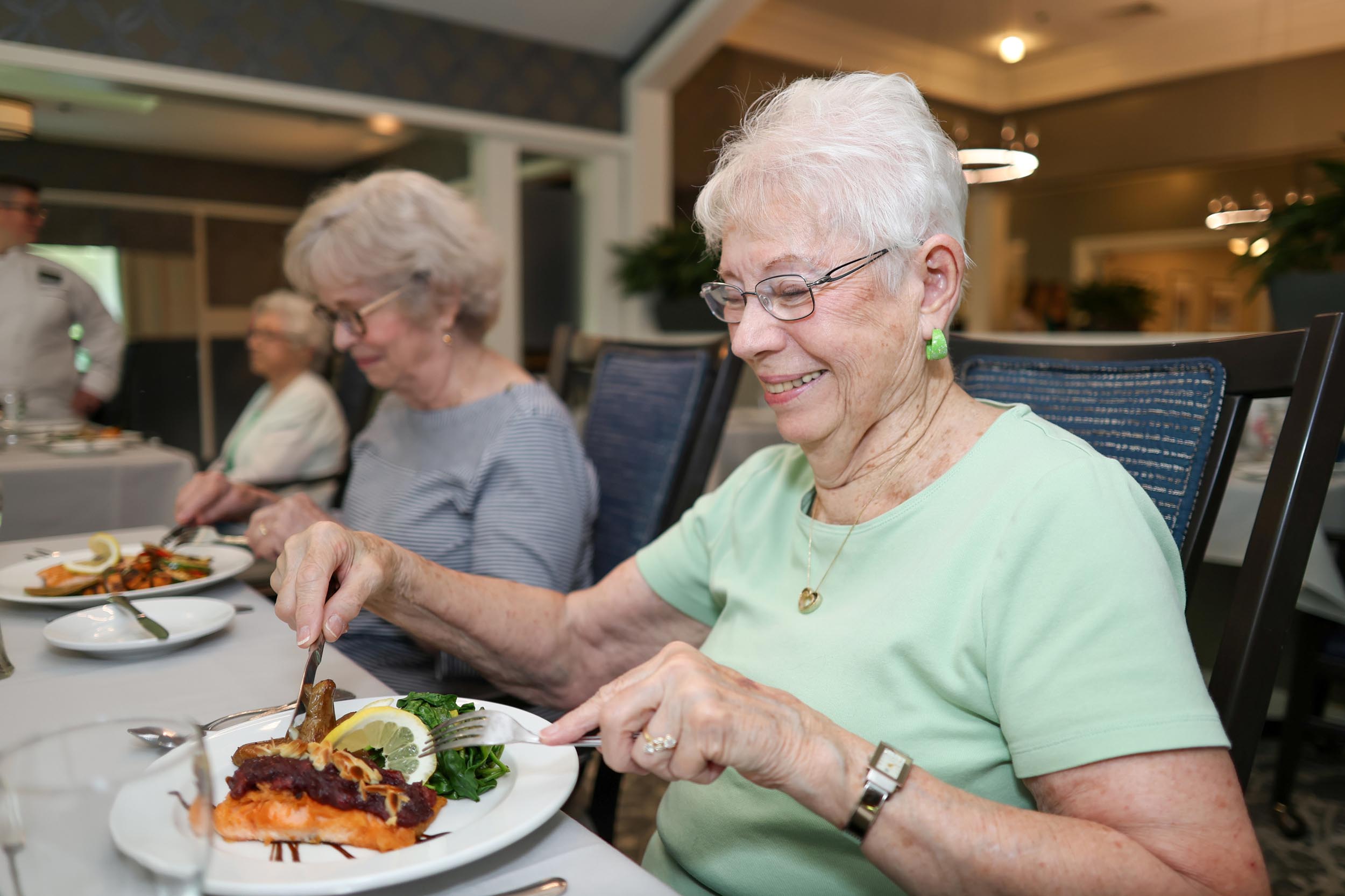 Residents eating delicious meals in the dining room