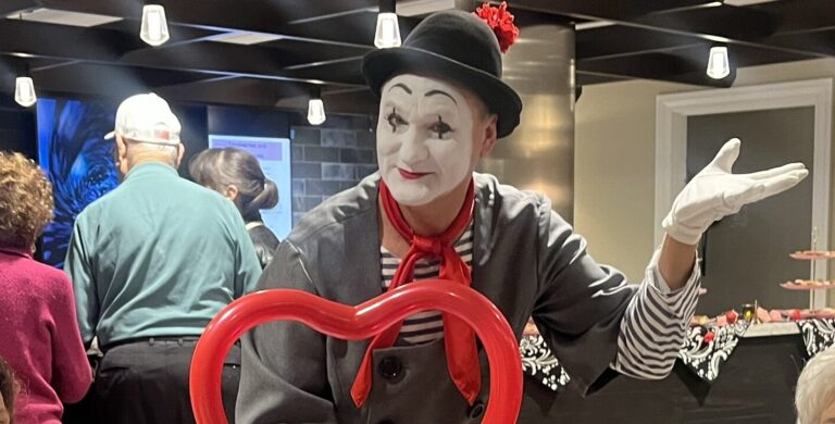 two older women with a mime