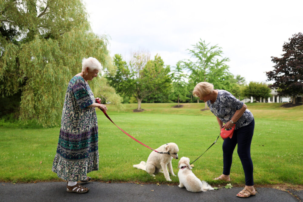 Residents Trudy W. and Bev W. enjoy pet-friendly Independent Living at New Pond Village.